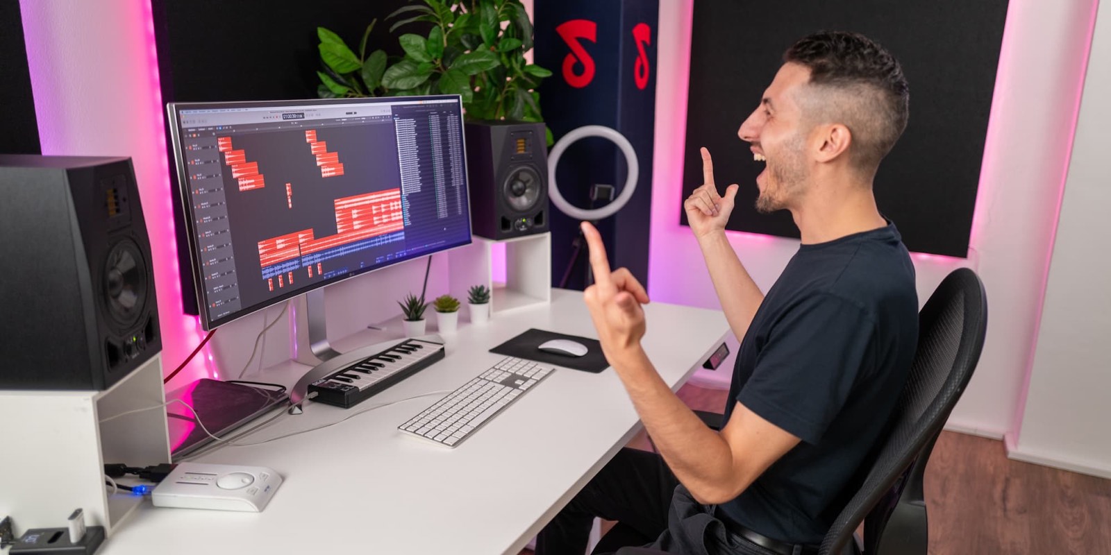 Oriano celebrating a finished dance mix at his studio desk